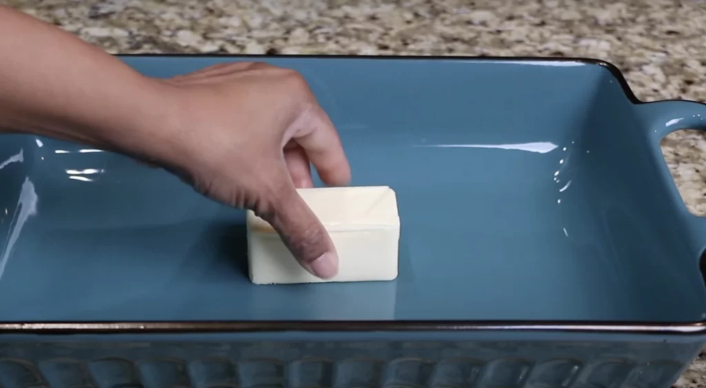 adding the butter to the baking dish 